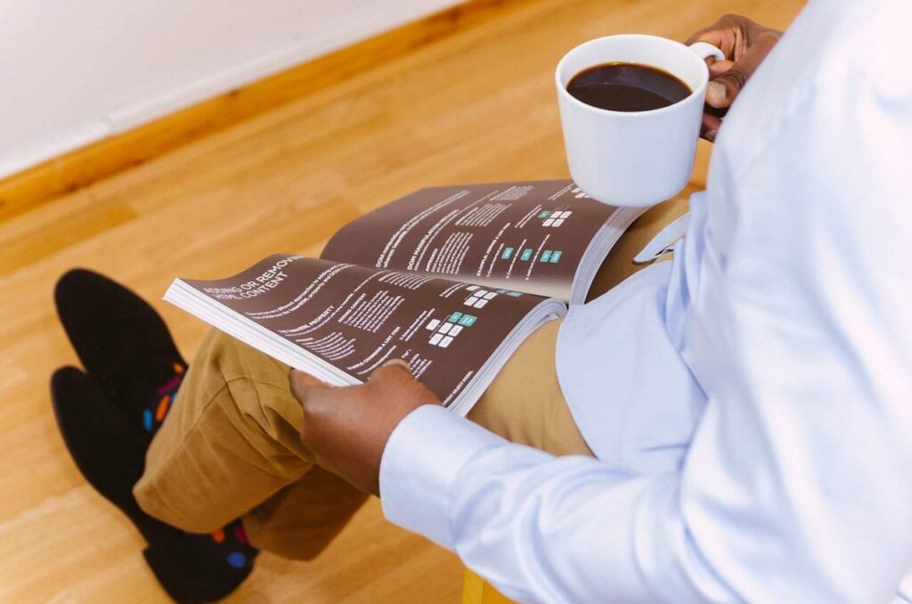 Professional reading a business book.|